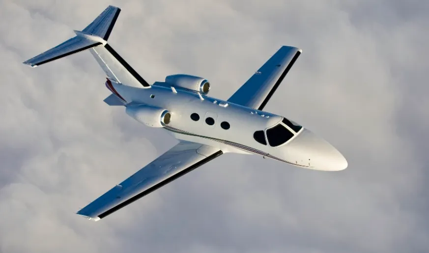 A private jet flies through the sky