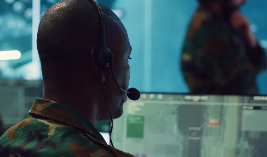 Photo of military personnel remotely monitors aircraft data
