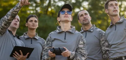 Photo of Goverment people looking at the sky testing a drone