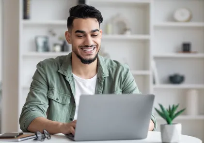 Photo of a man using a laptop