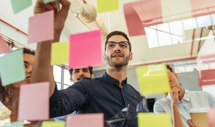 Photo of coworkers brainstorming with sticky notes