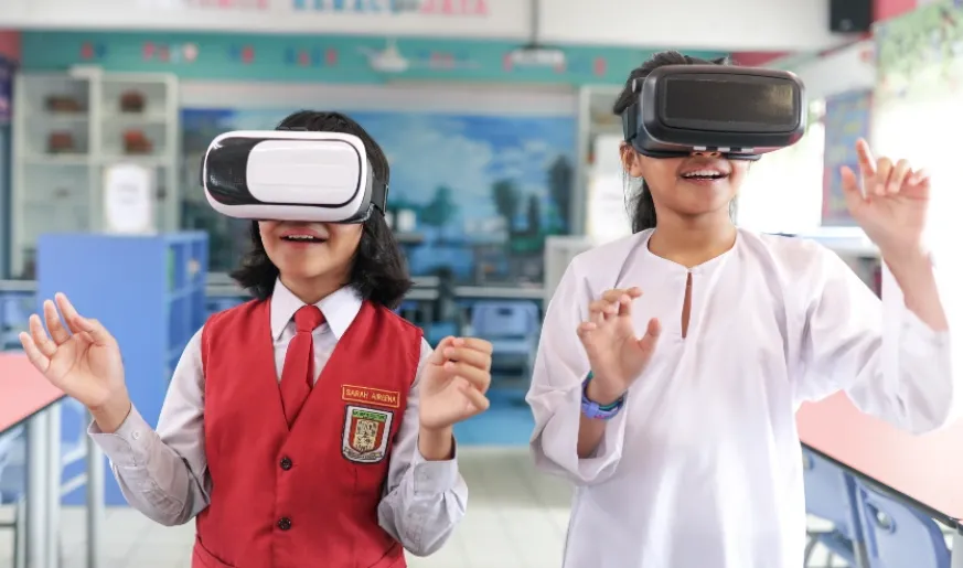 Photo of 2 students using VR headsets in a classroom