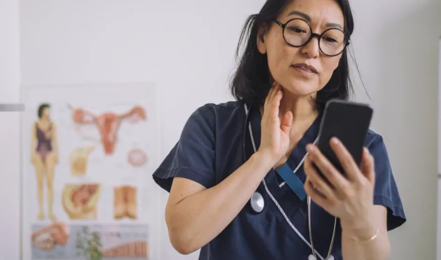 Photo of a remote doctor watching her phone