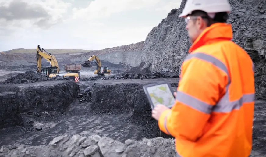 Photo of mining engineer using a tablet while at work