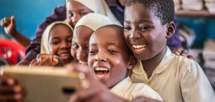Photo of young African children using their mobile through Wifi