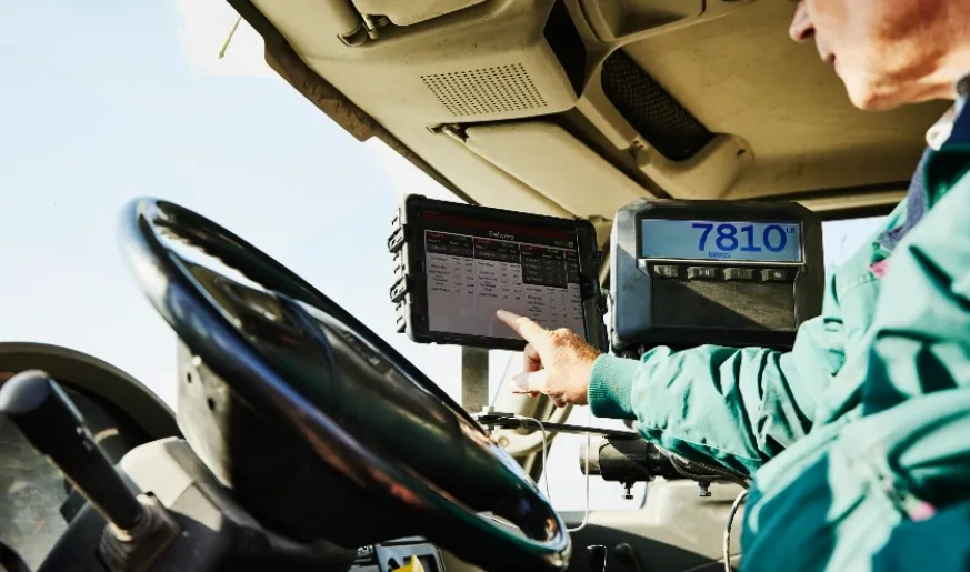 Photo of a connected truck driver using his device