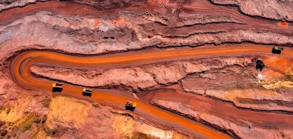 Earial photo of a mining site with three trucks on route