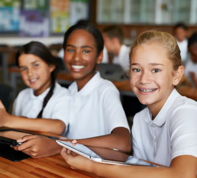Childrens smiling using a tablet