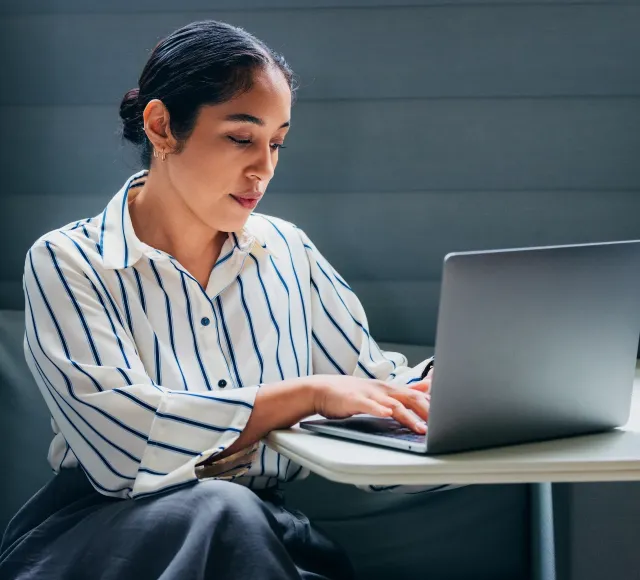 Photo of a corporate employee using her laptop