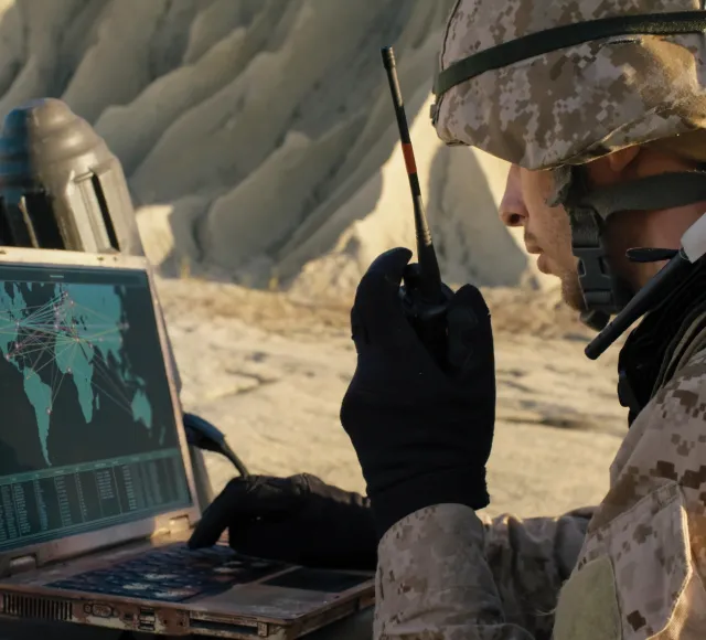 Photo of a solder using laptop and radio