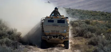 Photo of defence vehicle approaching through the fields