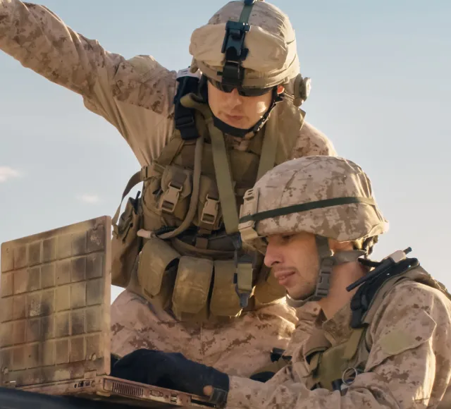Photo of soldiers using a laptop