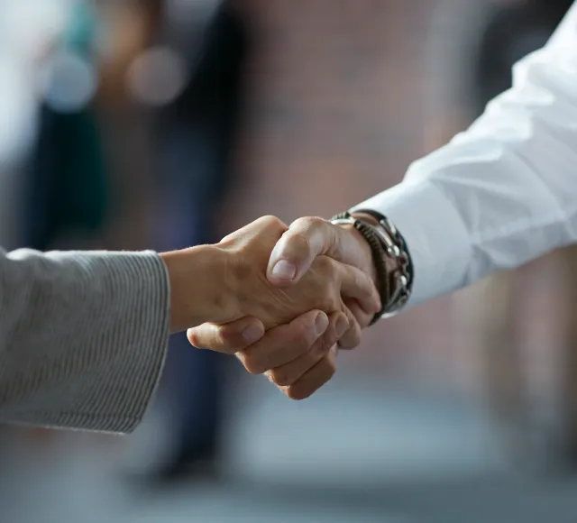 Photo of two hands doing a handshake