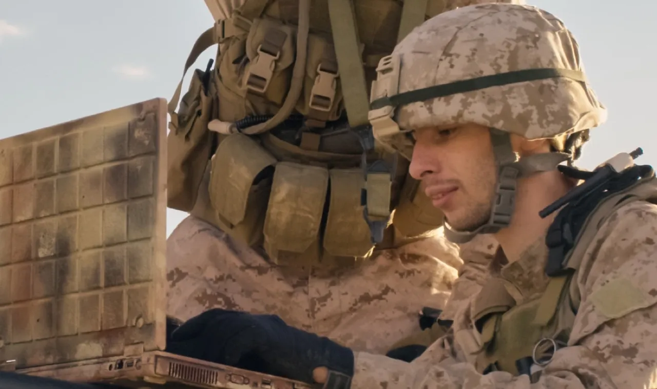 Image of government soldiers using their laptop