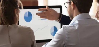 Photo of a person pointing at his monitor