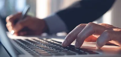 Photo of hands using a laptop