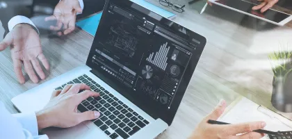 Photo of a person using a laptop in an office