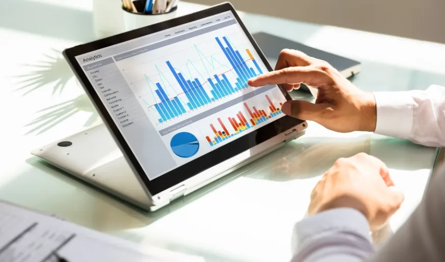 Photo of a person using a tablet with diagrams