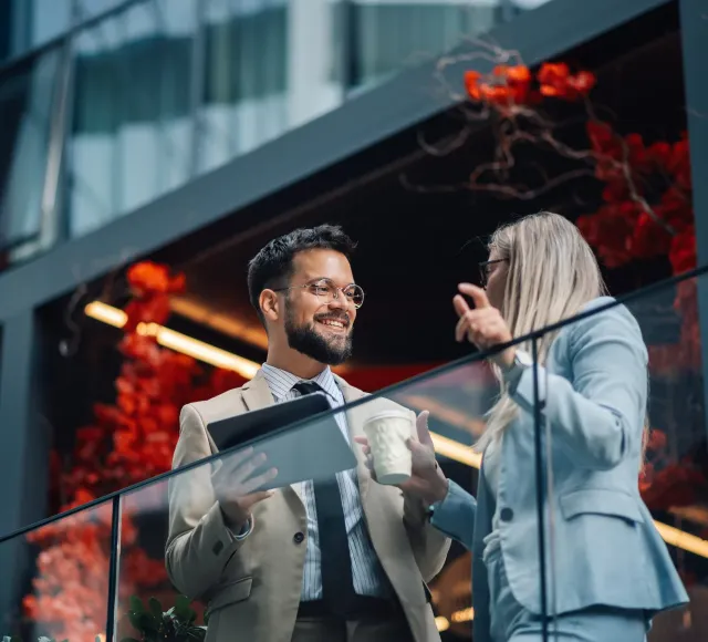 Photo of two corporate people talking with eachother