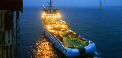 Photo of a ship shot from an offshore rig during early evening hours