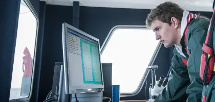 Scientists inspecting data on research ship 