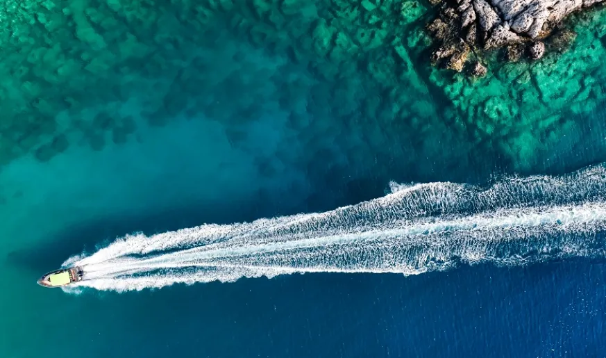Aerial photo of a boat moving in a bay