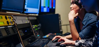 Photo of a woman editing at TV studio