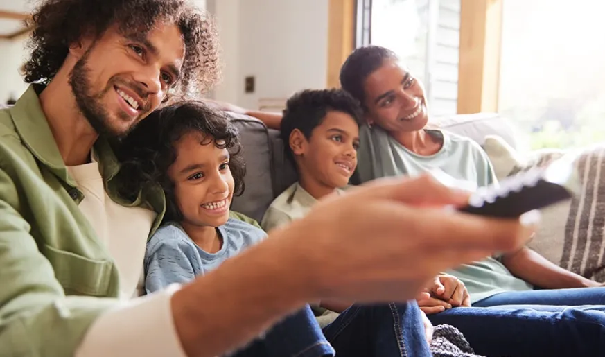 Photo of a father watching TV with sons