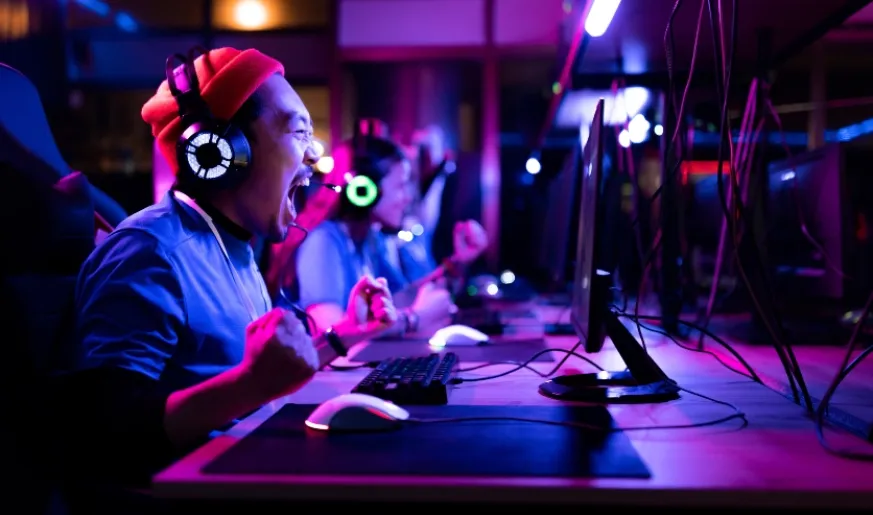 Photo of a happy gamer while at computer